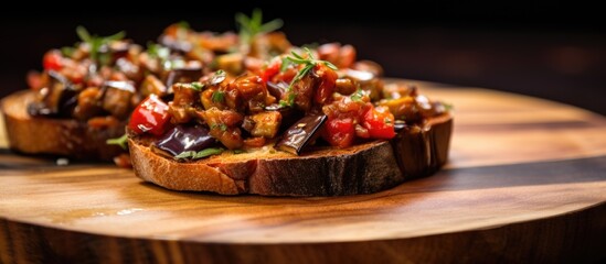 Close-up photo of Caponata, an Italian eggplant appetizer, on a wooden plate.