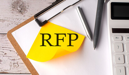 RFP word on a yellow sticky with calculator, pen and clipboard
