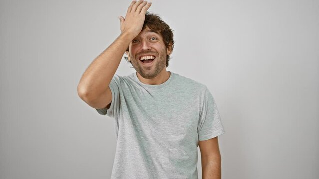 Oops! frustrated young man in t-shirt smacks forehead with hand, realizing stupid mistake. forgetful, handsome guy remembers error with annoyed regret. isolated on white background.