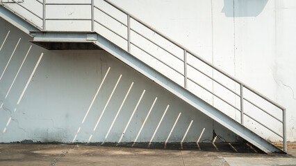 The metal with banister stair walkway outside a factory building, using as emergency exit or...