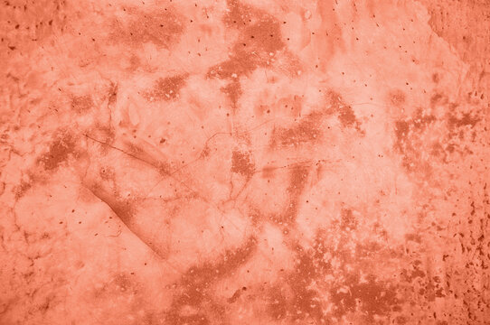 background, texture of concrete and stone in the color of 2024 peach fuzz. High quality photo