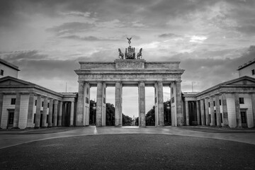 Brandenburg gate in Berlin, Germany. Black and white photography - obrazy, fototapety, plakaty