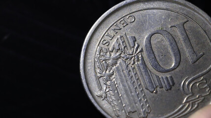 close-up of a 10 cent coin, detailing the numbers and scratches with a macro shot