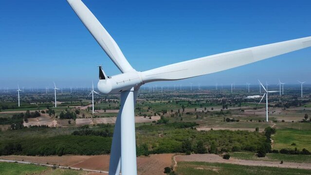 An aerial picture of a contemporary wind farm in motion that produces electricity. It is an example of environmental conservation and innovation in the electric business, and it is clean and renewable