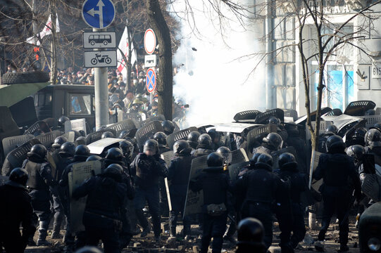 Policemen Berkut unit attacking protesters on Institutskaya street. Revolution of Dignity, the first street clashes. Kyiv, Ukraine