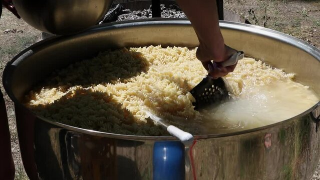 Tomato soup with pasta is a dish of Polish cuisine. Hot Zupa pomidorowa in a large cauldron at the field kitchen at a food fair. A popular soup made from grated tomatoes in their own juice.