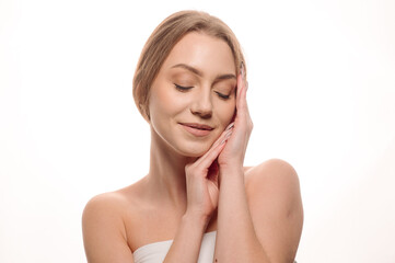 Portrait of a creative blonde woman in a beauty style on an isolated white background. Skin care concept