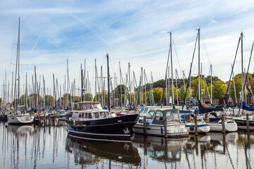 Sailing yachts and fishing boats moored in marina.Netherlands