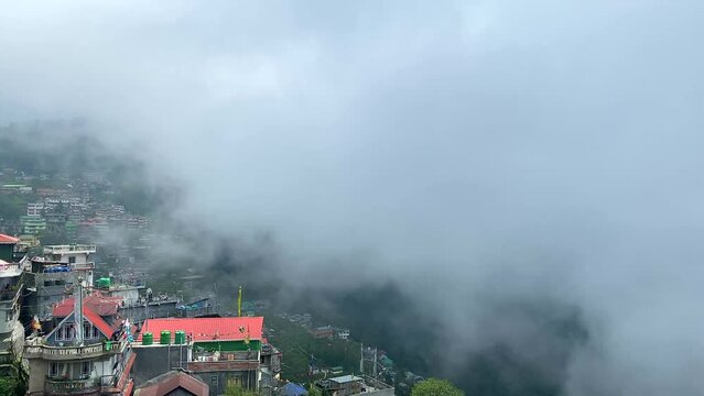 View of Darjeeling city over the a mountain in the himalayas on a cloudy day at west bengal, India.