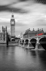 Westminster bridge with Big Ben and the Thames river, in London, UK. Black and white with red...