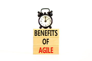 Benefits of agile symbol. Concept words Benefits of agile on beautiful wooden blocks. Beautiful white table white background. Black alarm clock. Business benefits of agile concept. Copy space.