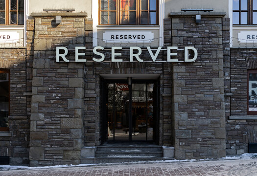 Reserved store entrance with logo sign. Polish clothing shop, apparel retailer, part of the LPP S.A. group. Signage with brand logotype on January 10, 2024 in Zakopane, Poland.