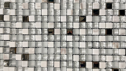 White glass mosaic in the bathroom. Light ceramic checkered wall and mosaic background in the kitchen. Geometric design pattern with wallpaper grid, texture.