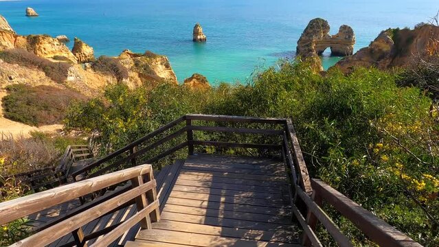 View of idyllic nature landscape with rocky cliff shore and waves crashing on. Camillo beach in Lagos. West Atlantic coast of Algarve region, south of Portugal.