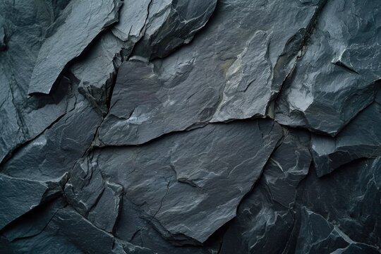 A detailed view of a black rock wall. This image can be used for backgrounds or textures