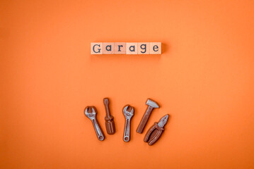 Tools and inscriptions symbolizing repairs or a garage and its attributes on a plain background