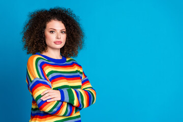 Photo portrait of attractive young woman folded arms confident pose wear trendy rainbow print clothes isolated on blue color background