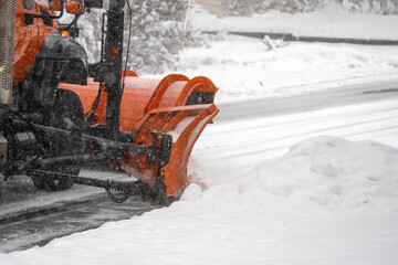 close up on snowplow driving on residential street