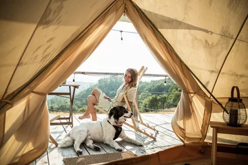 Selbstklebende Fototapeten glamping or glamour camping with a dog © Melinda Nagy