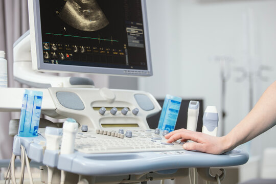 Modern medical equipment in the clinic. An ultrasound machine. Elastography and sonography. Doctor with a modern ultrasound machine, scanners and sensors close-up.