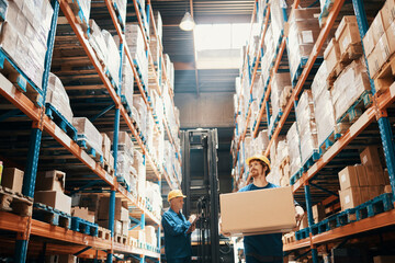 Young man carrying box in large warehouse