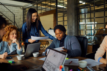 Team meeting of young diverse professionals in office