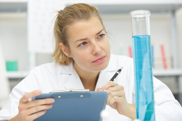 positive minded woman looking at a test tube