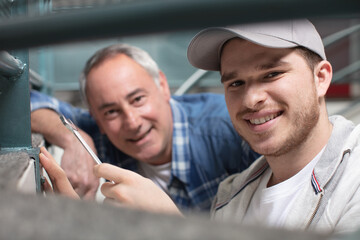 builder aprentice smiling with his teacher