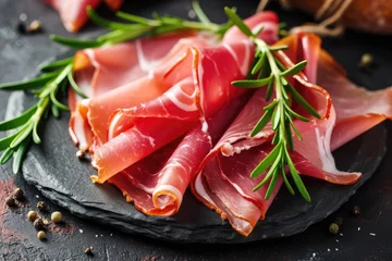 Foto op Plexiglas slices of tasty cured ham with decorated with rosmary © Salander Studio