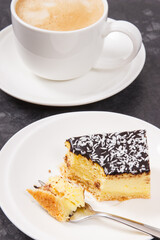 Fresh baked cheesecake and coffee with milk. Delicious dessert
