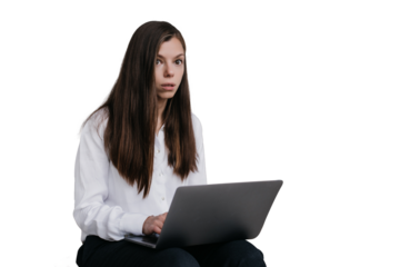 Scared young woman sitting with laptop against transparent background. Shocking news.