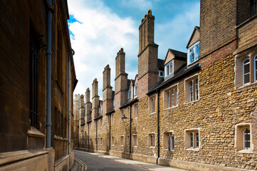 Narrow street with tall chimney stacks, Trinity Lane in Cambridge, England - 708017577