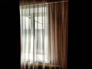 Window with dark curtains and tulle. Background, texture, pattern, place for text and copy space