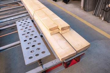 Wooden planks securely fastened to a construction trailer at a building supply store, preparations...