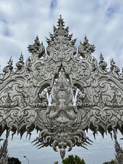 Fototapeta na wymiar The White Temple (Wat Rong Khun), Chiang Rai, North Thailand. Its striking white color and the use of mirrors in its design are unique features that contribute to its ethereal beauty and symbolism.
