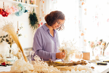Focused lady working in floral shop