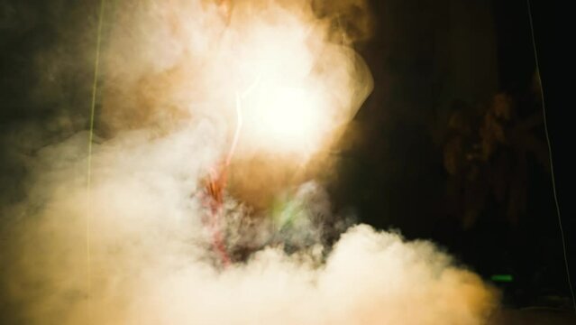 Sexy woman retro lady smoker holding cigarette in hands. art portrait glamour dark silhouette girl long red shiny dress. hair 20s 30s old style. Black burning room scene full smoke flare light. 60s 4k