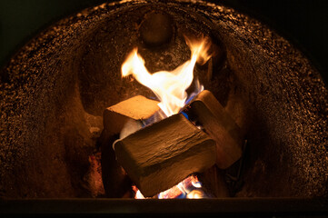 Wood briquettes (ruf type), made of beech and oak burning inside the wood fuel boiler. Alternative fuel, eco fuel, bio fuel.