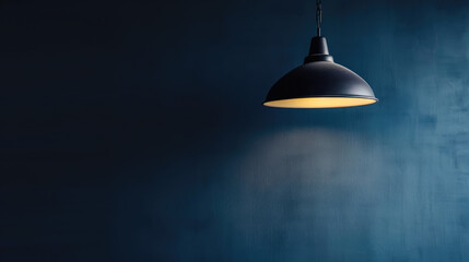 Obraz premium A lamp hangs against a dark wall, casting its light and illuminating the area, with space available for text or presentation.