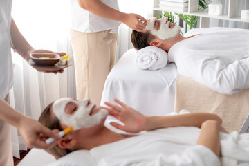 Serene ambiance of spa salon, couple indulges in rejuvenating with luxurious face cream massage...