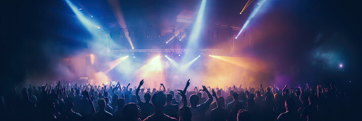 Energetic live music concert with a crowd of fans cheering and dancing under the glow of stage...