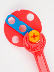 children's colorful plastic construction set, which includes an electric drill, screws, bolts and screwdrivers. various details and twisting. view from above.