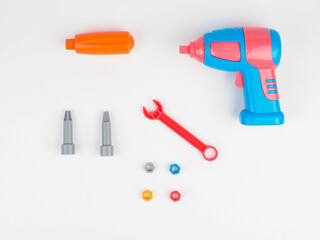 children's colorful plastic construction set, which includes an electric drill, screws, bolts and screwdrivers. view from above.