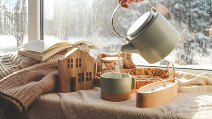 Pouring a cup of tea, cozy home photo