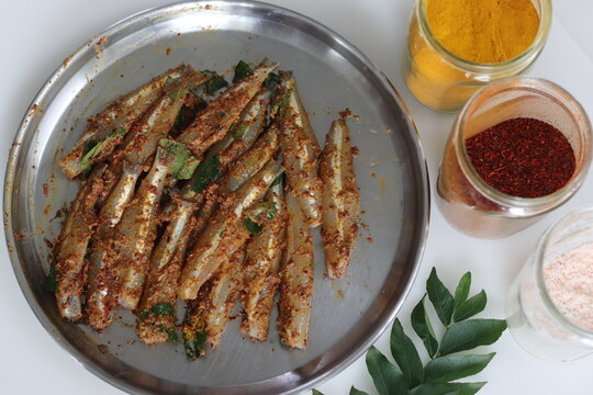 Freshly cut, cleaned and marinated anchovy fish presented on a steel plate