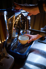 Barista preparing coffee for customer in coffee machine