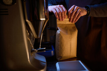 Coffee maker unpack package with coffee beans before espresso brewing