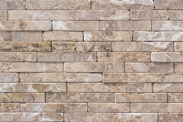 White and brown color brick wall including cream inclusions closeup, as background, texture closeup. Brick tiles for decorative paving exteriors and parking lots. Building materials