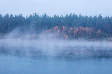 fog over large lake in autumn - 708050162