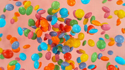 Freeze motion of flying various kind of candies. Colored abstract sweet background.